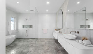 Elegant dual vanity ensuite bathroom, with custom stone basins, and walk in double shower with brass tapware.