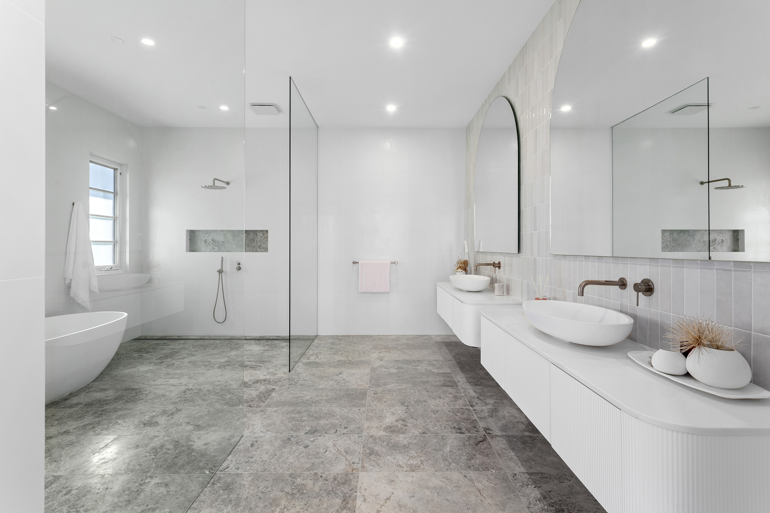 Elegant dual vanity ensuite bathroom, with custom stone basins, and walk in double shower with brass tapware.