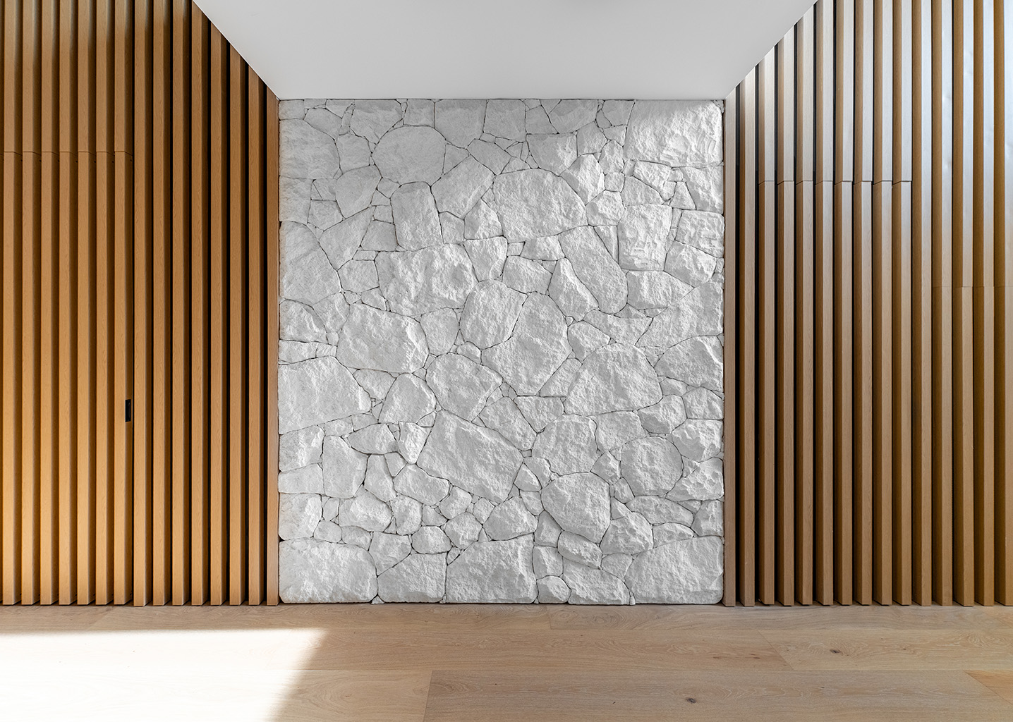 Stone wall with designer aluminium battens