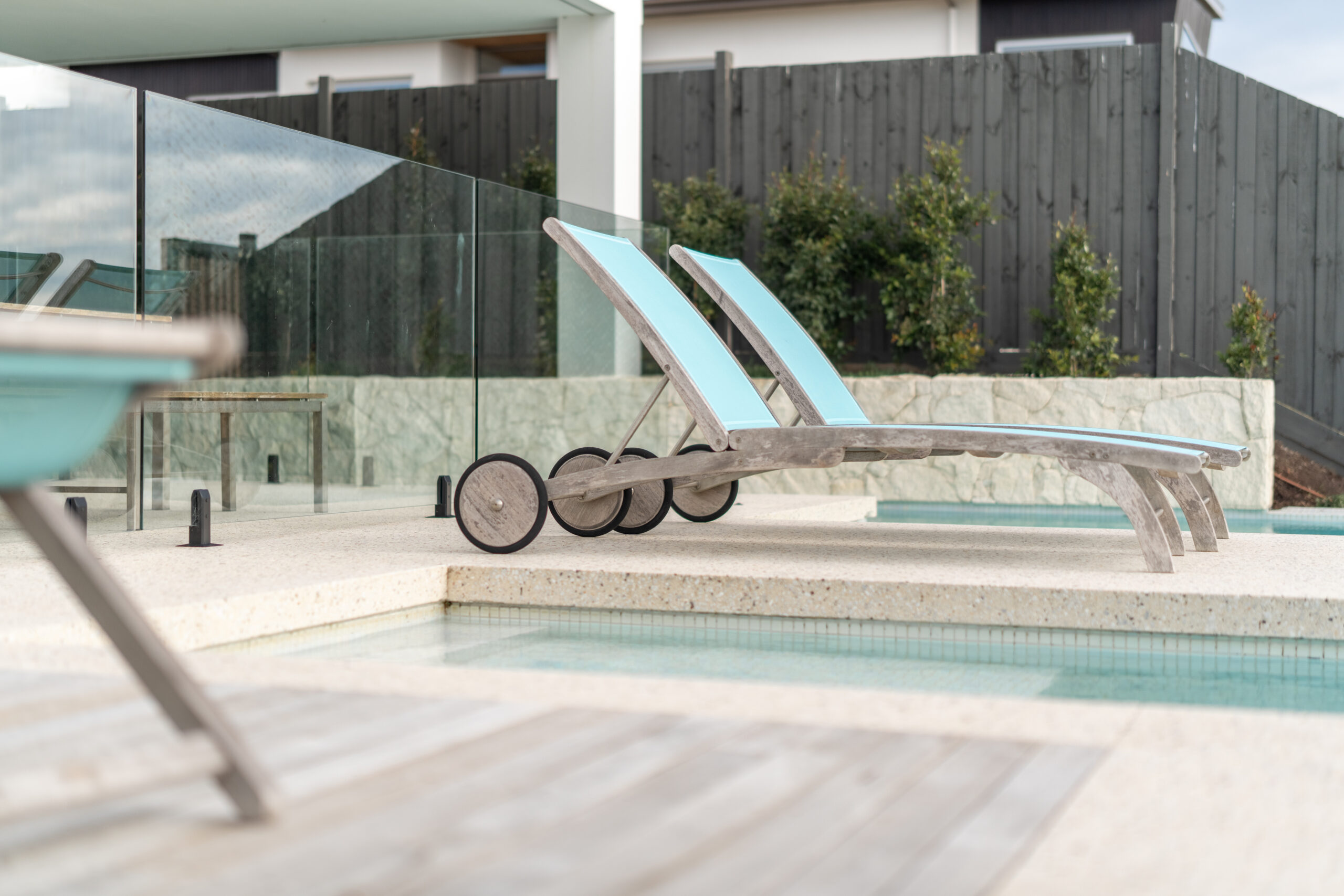 Combination coastal decking, stone poolside tiles and custom sourced pool tiling.