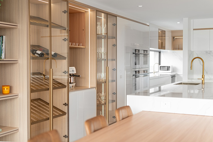 Contemporary, minimalism style kitchen boasting lifestyle concsious, custom cabinetry, island bench extending into a dining table for entertaining.