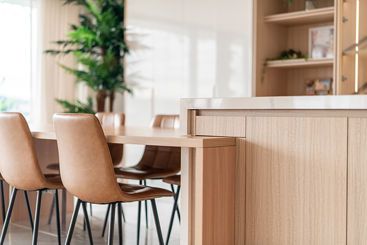 Refined joinery, completing custom kitchen cabinetry and benchtops, extending into a functional dining table.