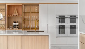 Contemporary, minimalism style kitchen boasting lifestyle concsious, custom cabinetry, island bench extending into a dining table for entertaining.